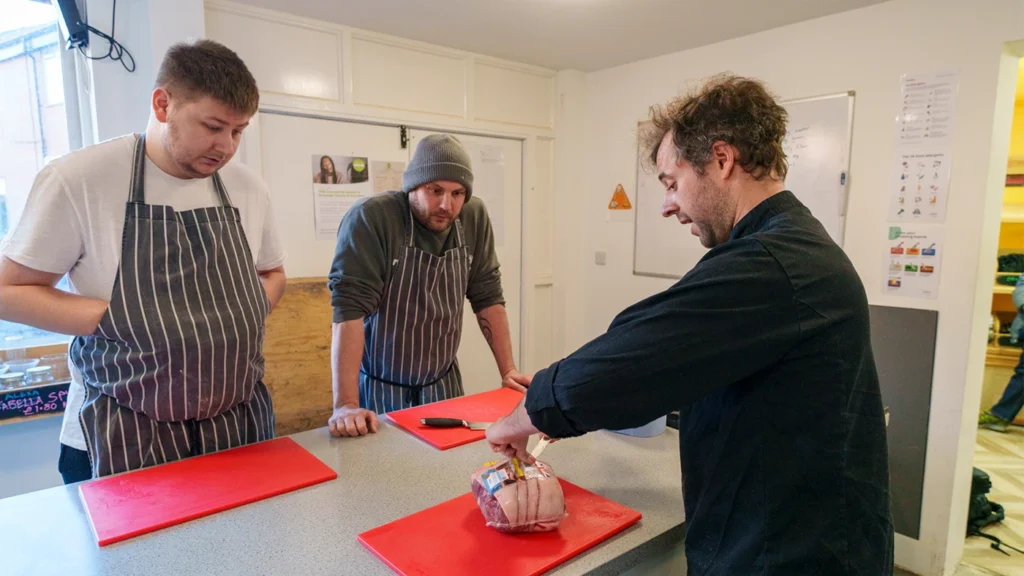 Cookery students with tutor at Giroscope Kitchen 23