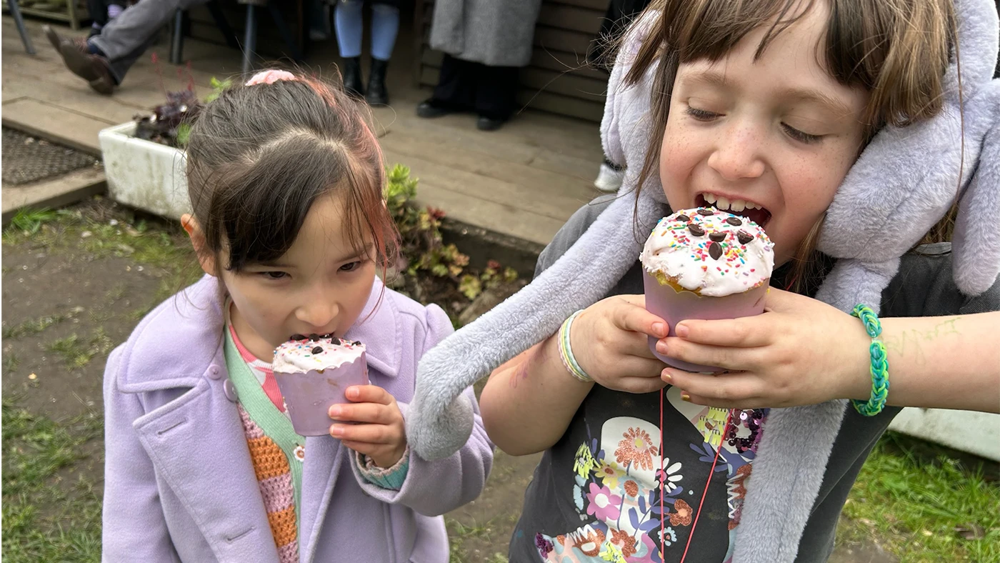 Two children eating Easter Cake