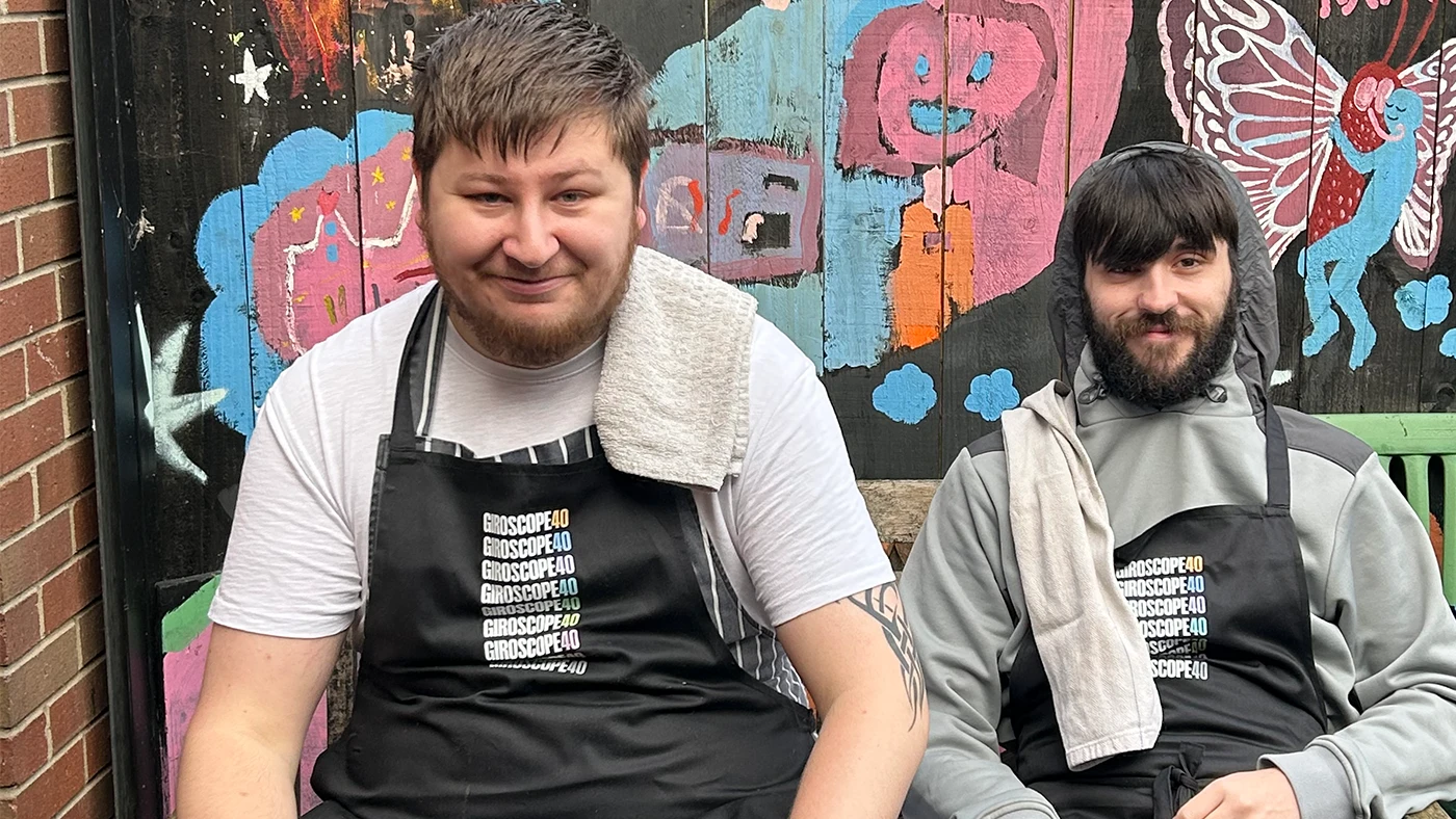 Two young chefs after smiling after finishing cookery course